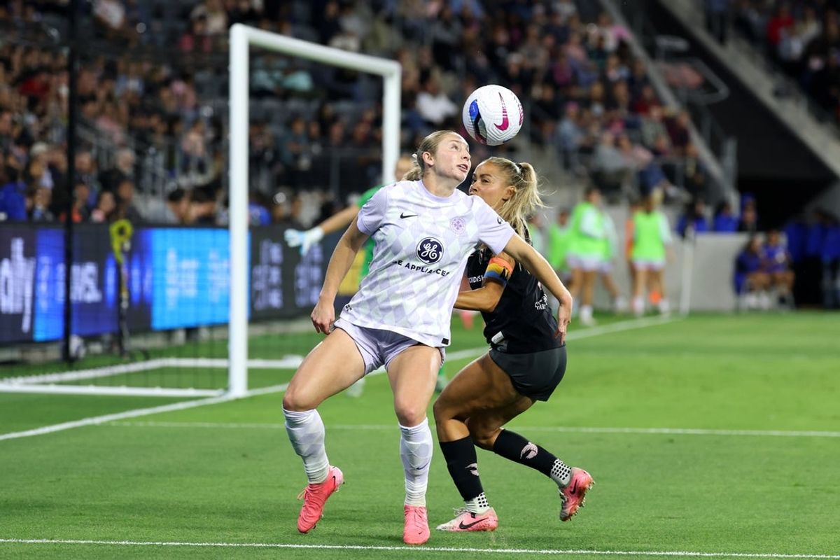 May 24, 2025; Los Angeles, California, USA;  Racing Louisville FC forward Sarah Weber (42) fights for the ball against Angel City FC defender Sarah Gorden (11) during the second half at BMO Stadium. Mandatory Credit: Kiyoshi Mio-Imagn Images