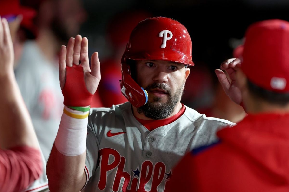May 24, 2025; West Sacramento, California, USA; Philadelphia Phillies designated hitter Kyle Schwarber (12) is congratulated by teammates in the dugout after scoring a run against the Athletics during the eleventh inning at Sutter Health Park. Mandatory Credit: Dennis Lee-Imagn Images