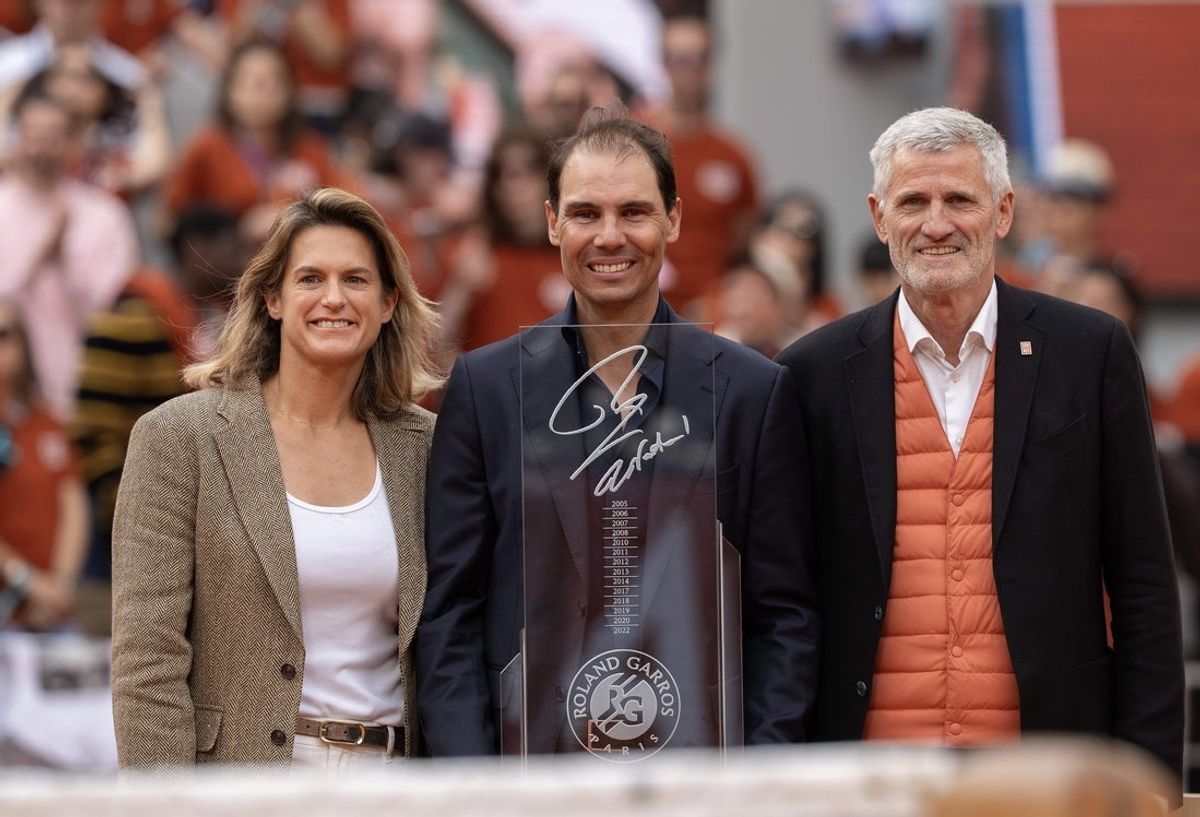 May 25, 2025; Paris, FR; Tournament Director, Amelie Mauresmo and FFT President, Gilles Moretton present Rafael Nadal of Spain a special trophy during the presentation ceremony paying tribute to his career on a packed Court Philippe Chatrier Courtday on day one at Roland Garros Stadium. Mandatory Credit: Susan Mullane-Imagn Images