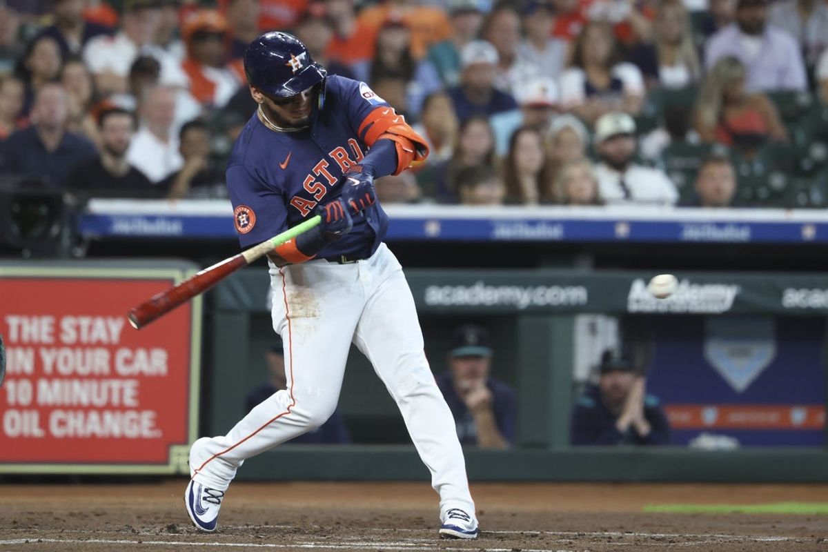 May 25, 2025; Houston, Texas, USA; Houston Astros third baseman Isaac Paredes (15) hits a single during the first inning against the Seattle Mariners at Daikin Park. Mandatory Credit: Troy Taormina-Imagn Images