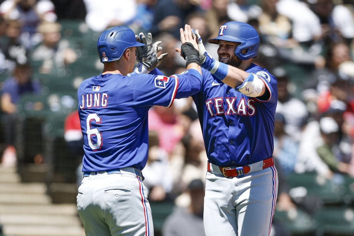 May 25, 2025; Chicago, Illinois, USA; Texas Rangers first baseman Jake Burger (21) celebrates with third baseman Josh Jung (6) after hitting a two-run home run against the Chicago White Sox during the second inning at Rate Field. Mandatory Credit: Kamil Krzaczynski-Imagn Images