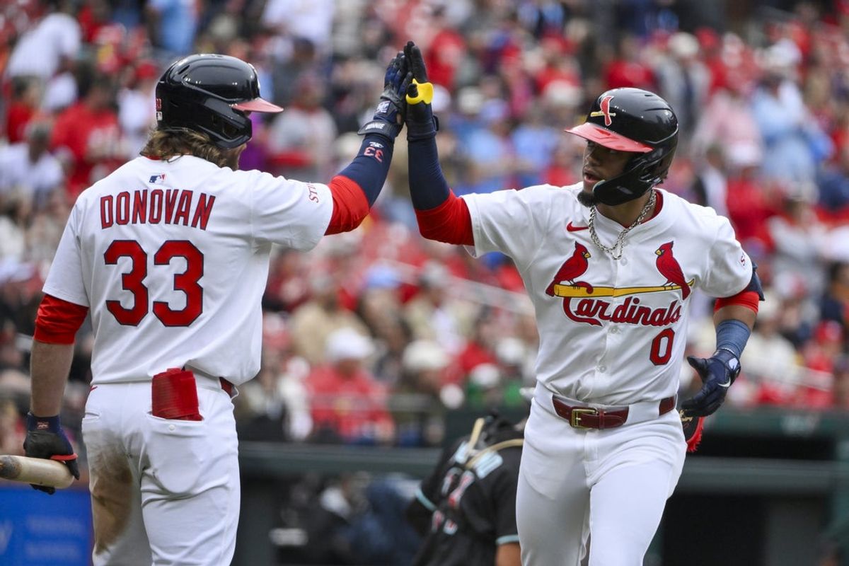 May 25, 2025; St. Louis, Missouri, USA;  St. Louis Cardinals shortstop Masyn Winn (0) is congratulated by second baseman Brendan Donovan (33) after hitting a solo home run against the Arizona Diamondbacks during the third inning at Busch Stadium. Mandatory Credit: Jeff Curry-Imagn Images
