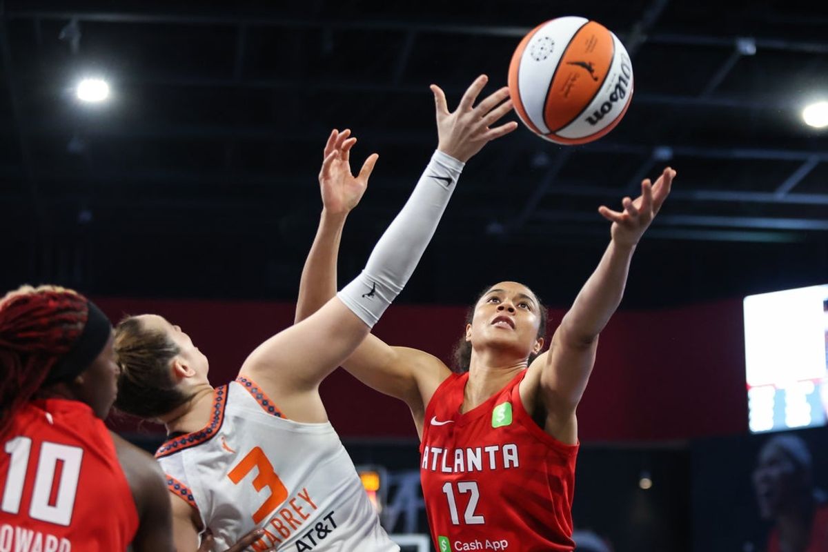 May 25, 2025; College Park, Georgia, USA; Connecticut Sun guard Marina Mabrey (3) reaches for the rebound against Atlanta Dream forward Nia Coffey (12) during the first quarter at Gateway Center Arena at College Park. Mandatory Credit: Jordan Godfree-Imagn Images