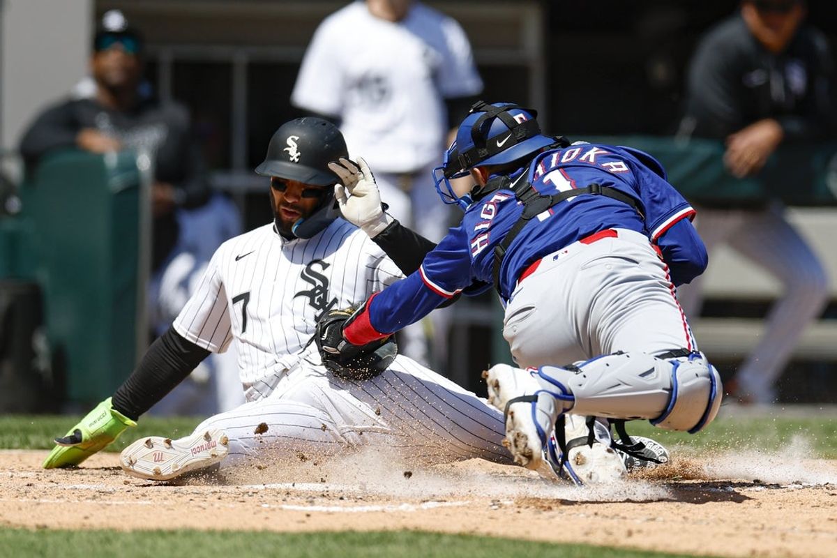May 25, 2025; Chicago, Illinois, USA; Texas Rangers catcher Kyle Higashioka (11) tags out at home plate Chicago White Sox catcher Edgar Quero (7) during the fifth inning at Rate Field. Mandatory Credit: Kamil Krzaczynski-Imagn Images