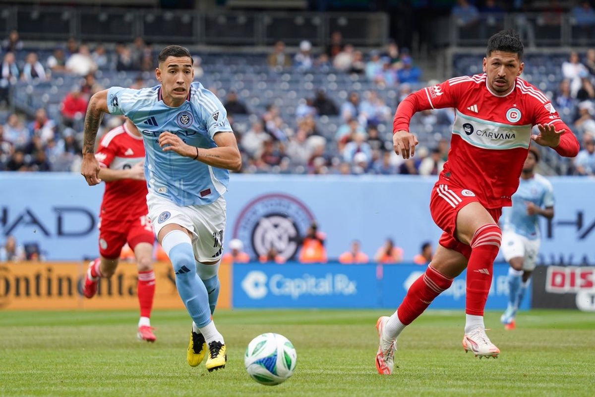 May 25, 2025; New York, New York, USA; New York City FC forward Julian Fernandez (11) dribbles alongside Chicago Fire FC defender Mauricio Pineda (22) during the first half at Yankee Stadium. Mandatory Credit: Lucas Boland-Imagn Images