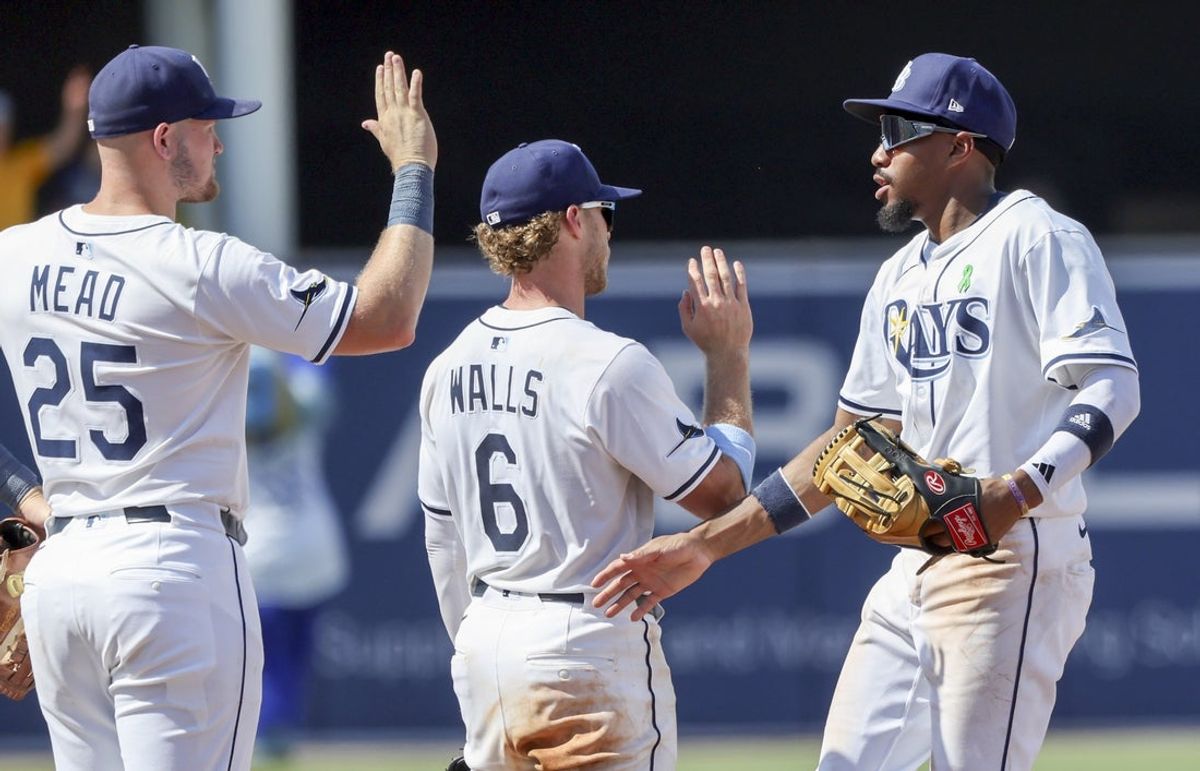 May 25, 2025; St. Petersburg, Florida, USA; Tampa Bay Rays outfielder Chandler Simpson (14), shortstop Taylor Walls (6) and infielder Curtis Mead (25) high five after they beat the Toronto Blue Jays at George M. Steinbrenner Field. Mandatory Credit: Kim Klement Neitzel-Imagn Images