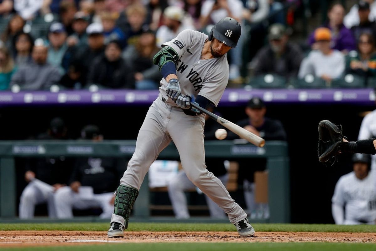 May 25, 2025; Denver, Colorado, USA; New York Yankees catcher J.C. Escarra (25) hits an RBI double in the second inning against the Colorado Rockies at Coors Field. Mandatory Credit: Isaiah J. Downing-Imagn Images
