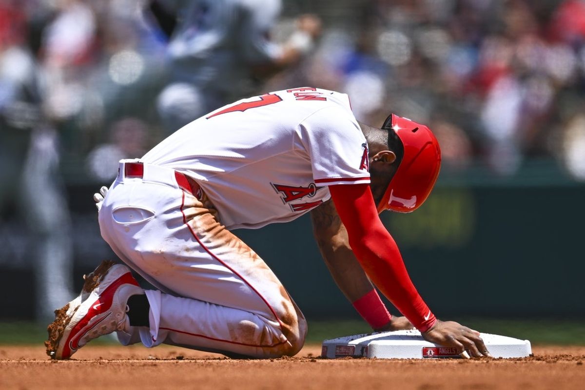 May 25, 2025; Anaheim, California, USA; Los Angeles Angels shortstop Tim Anderson (77) forced out at second base against the Miami Marlins during the first inning at Angel Stadium. Mandatory Credit: Jonathan Hui-Imagn Images