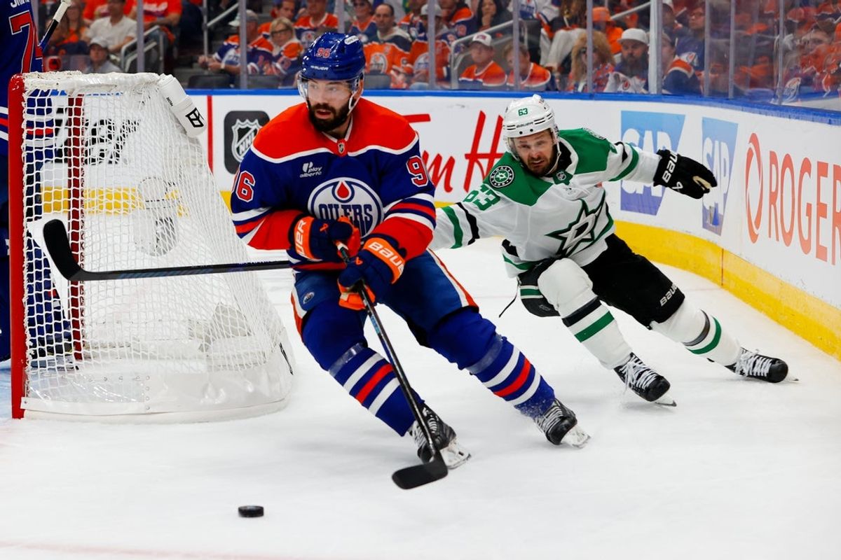 May 25, 2025; Edmonton, Alberta, CAN; Edmonton Oilers defenseman Jake Walman (96) keeps the puck away from Dallas Stars right wing Evgenii Dadonov (63) in game three of the Western Conference Final of the 2025 Stanley Cup Playoffs at Rogers Place. Mandatory Credit: Perry Nelson-Imagn Images