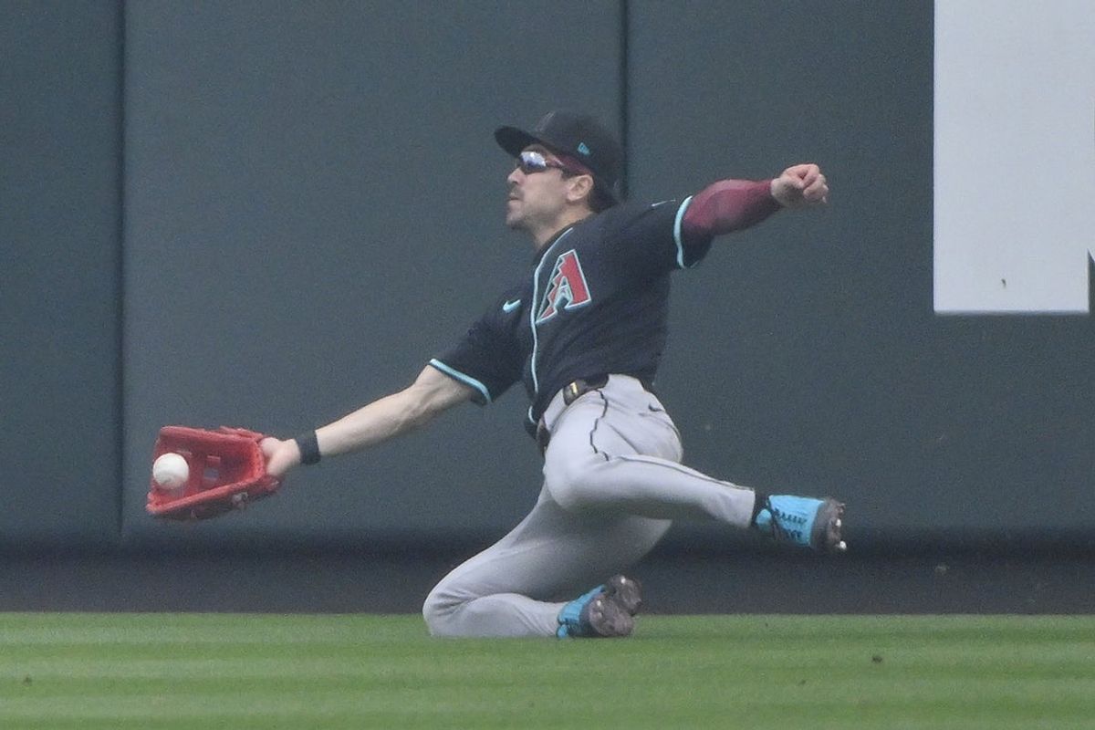 May 25, 2025; St. Louis, Missouri, USA;  Arizona Diamondbacks right fielder Corbin Carroll (7) dives and catches a fly ball against the St. Louis Cardinals during the third inning at Busch Stadium. Mandatory Credit: Jeff Curry-Imagn Images