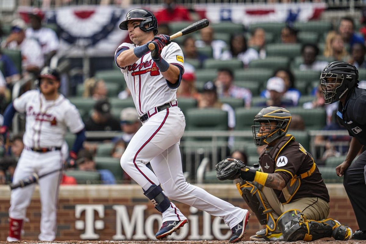 May 25, 2025; Cumberland, Georgia, USA; Atlanta Braves third baseman Austin Riley (27) hits a single against the San Diego Padres during the first inning at Truist Park. Mandatory Credit: Dale Zanine-Imagn Images