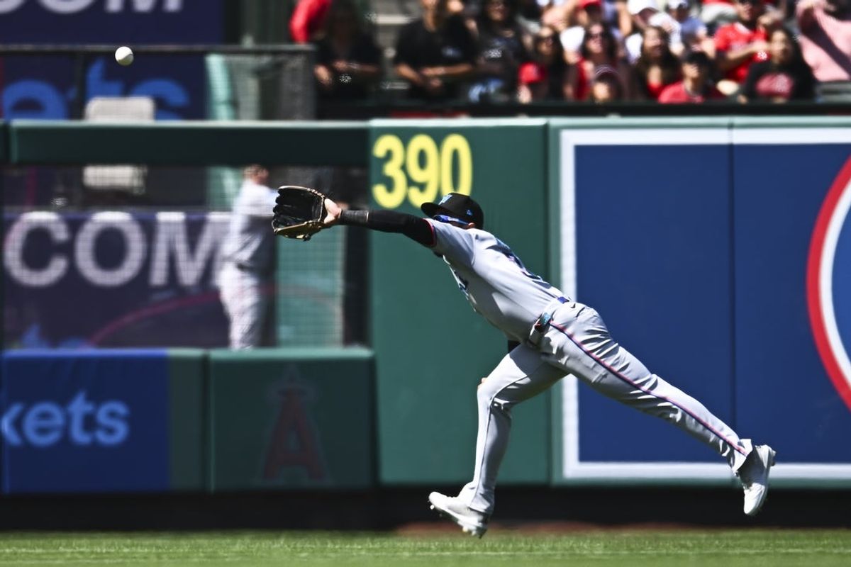 May 25, 2025; Anaheim, California, USA; Miami Marlins outfielder Derek Hill (3) makes a catch against the Los Angeles Angels during the eighth inning at Angel Stadium. Mandatory Credit: Jonathan Hui-Imagn Images