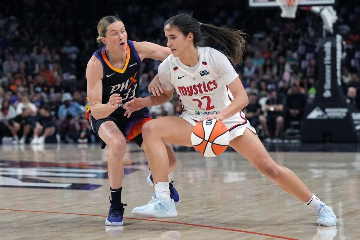 May 25, 2025; Phoenix, Arizona, USA; Washington Mystics guard Sonia Citron (22) drives on Phoenix Mercury guard Sami Whitcomb (33) in the first half at Footprint Center. Mandatory Credit: Rick Scuteri-Imagn Images