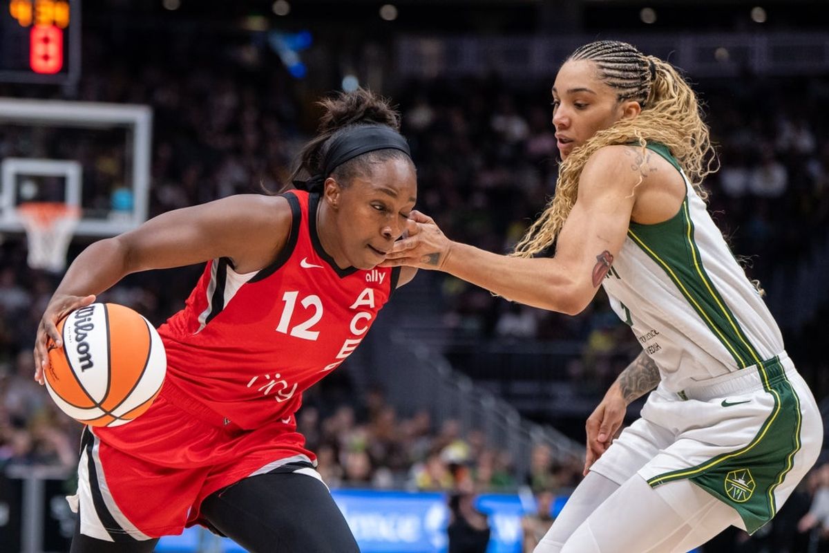 May 25, 2025; Seattle, Washington, USA;  Las Vegas Aces guard Chelsea Gray (12) drives against Seattle Storm forward Gabby Williams (5) during the first half at Climate Pledge Arena. Mandatory Credit: Stephen Brashear-Imagn Images