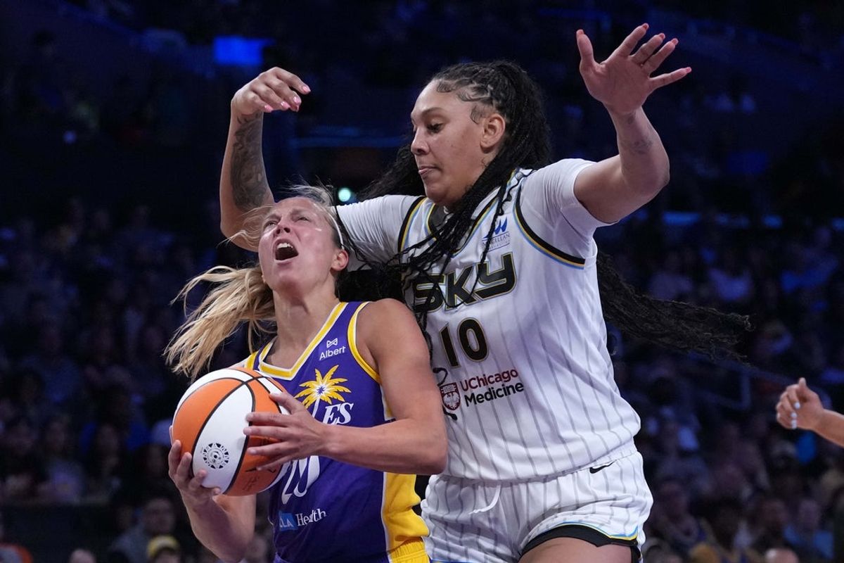 May 25, 2025; Los Angeles, California, USA; LA Sparks guard Julie Allemand (20) is fouled by Chicago Sky center Kamilla Cardoso (10) in the first half at Crypto.com Arena. Mandatory Credit: Kirby Lee-Imagn Images