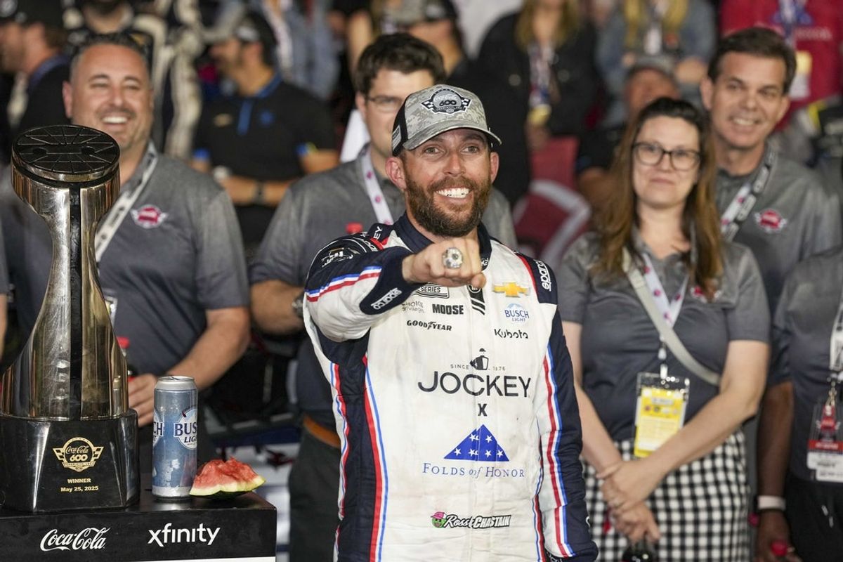 May 25, 2025; Concord, North Carolina, USA; NASCAR Cup Series driver Ross Chastain (1) shows off his diamond ring for winning the Coca Cola 600 at Charlotte Motor Speedway. Mandatory Credit: Jim Dedmon-Imagn Images
