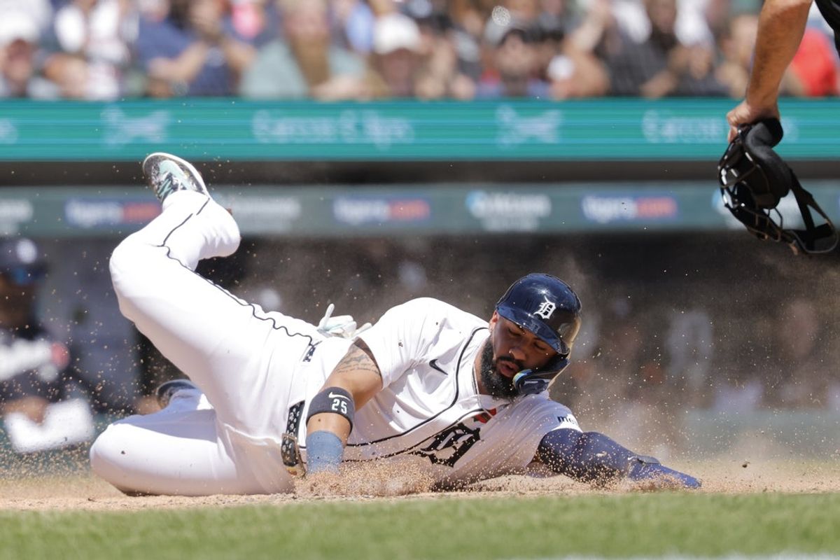 May 26, 2025; Detroit, Michigan, USA;  Detroit Tigers second base Gleyber Torres (25) slides in safe at home in the fifth inning against the San Francisco Giants at Comerica Park. Mandatory Credit: Rick Osentoski-Imagn Images