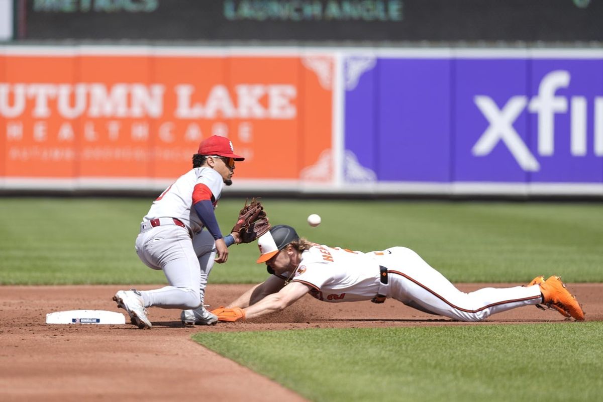 May 26, 2025; Baltimore, Maryland, USA; Baltimore Orioles shortstop Gunnar Henderson (2) is tagged out attempting to steal second base by St. Louis Cardinals shortstop Masyn Winn (0) during the first inning at Oriole Park at Camden Yards. Mandatory Credit: Gregory Fisher-Imagn Images