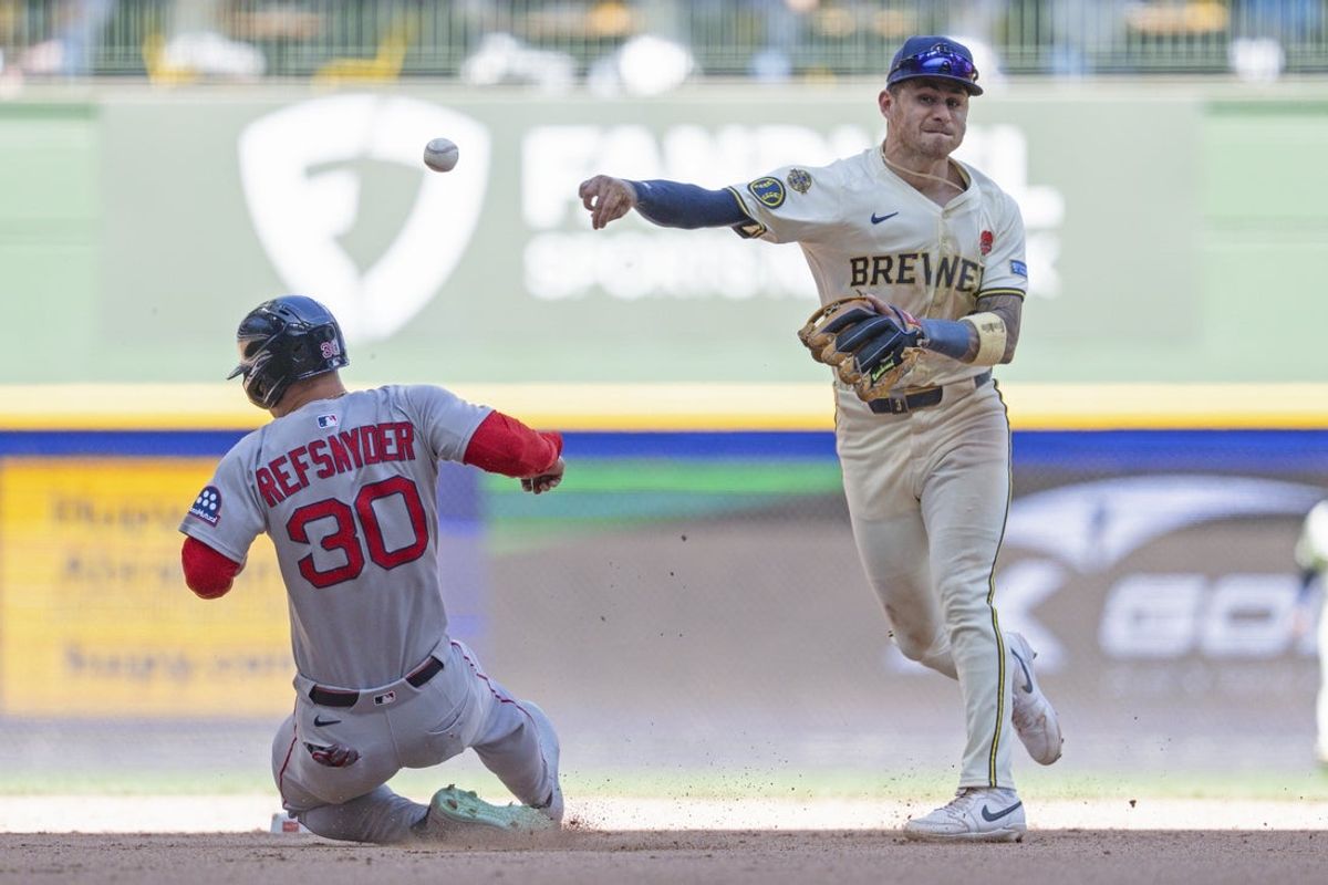 May 26, 2025; Milwaukee, Wisconsin, USA;  Milwaukee Brewers shortstop Joey Ortiz (3) turns a double play as Boston Red Sox pinch hitter Rob Refsnyder (30) slides into second base during the seventh inning at American Family Field. Mandatory Credit: Jeff Hanisch-Imagn Images