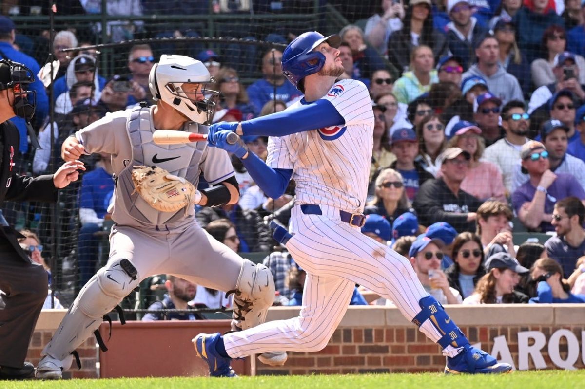 May 26, 2025; Chicago, Illinois, USA; Chicago Cubs right fielder Kyle Tucker (30) hits an RBI sacrifice fly ball during the seventh inning against the Colorado Rockies at Wrigley Field. Mandatory Credit: Patrick Gorski-Imagn Images