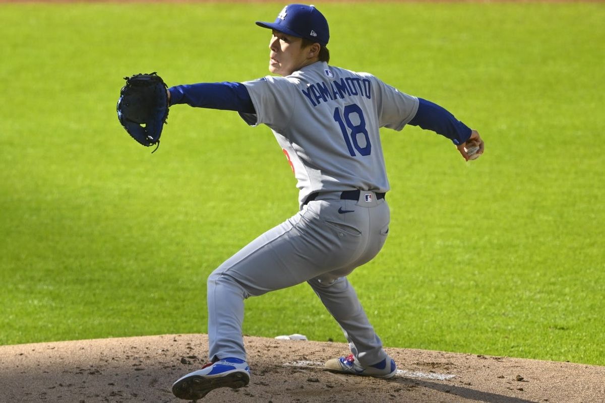 May 26, 2025; Cleveland, Ohio, USA; Los Angeles Dodgers starting pitcher Yoshinobu Yamamoto (18) delivers a pitch in the first inning against the Cleveland Guardians at Progressive Field. Mandatory Credit: David Richard-Imagn Images