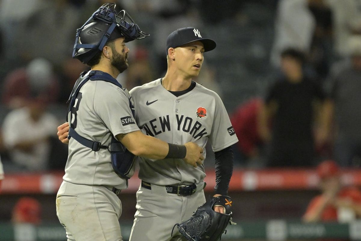 May 26, 2025; Anaheim, California, USA;  New York Yankees relief pitcher Luke Weaver (30) is congratulated by catcher Austin Wells (28) after the final out of the ninth inning against the Los Angeles Angels at Angel Stadium. Mandatory Credit: Jayne Kamin-Oncea-Imagn Images