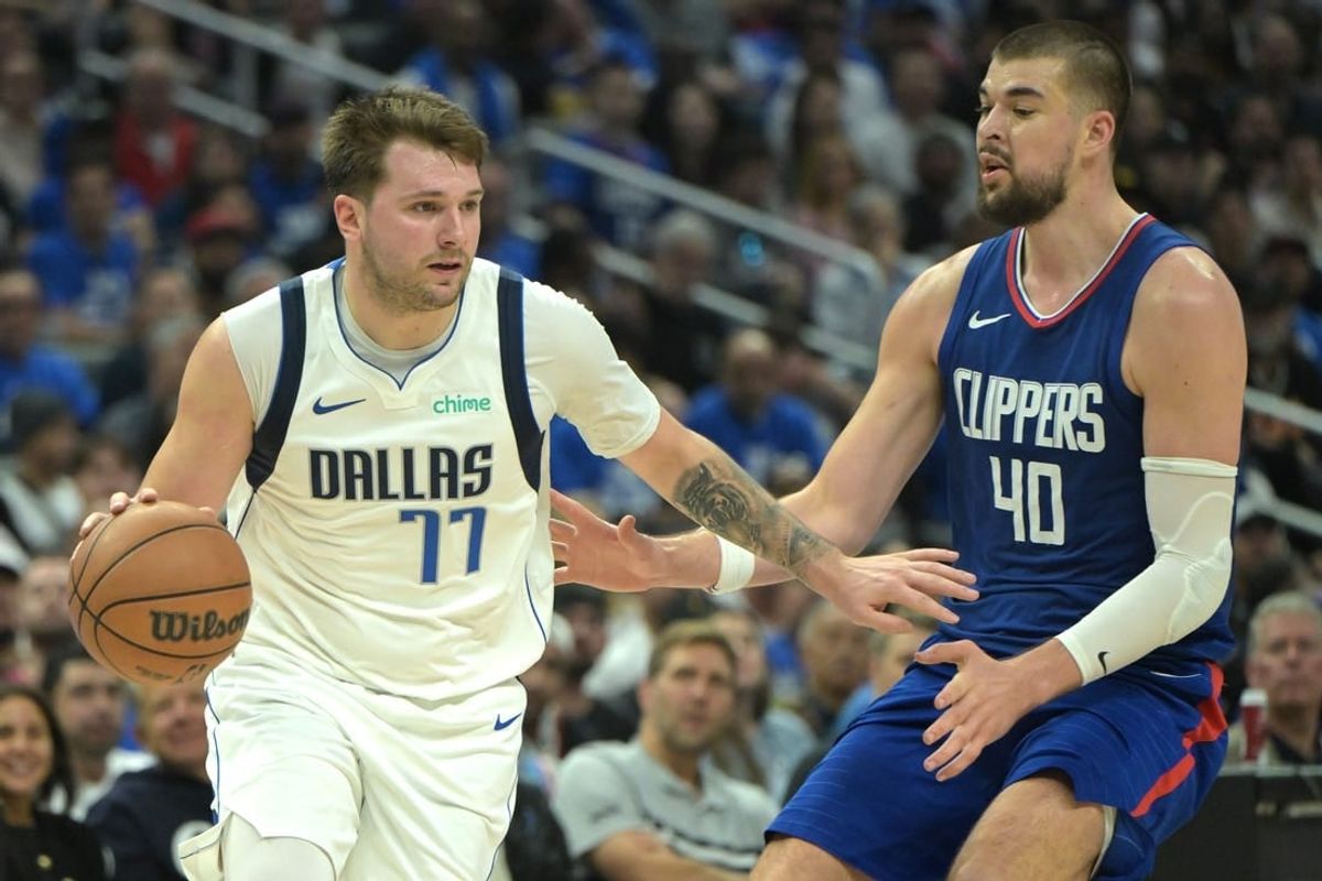 Apr 21, 2024; Los Angeles, California, USA; Dallas Mavericks guard Luka Doncic (77) is defended by Los Angeles Clippers center Ivica Zubac (40) in the second half of game one of the first round for the 2024 NBA playoffs at Crypto.com Arena.