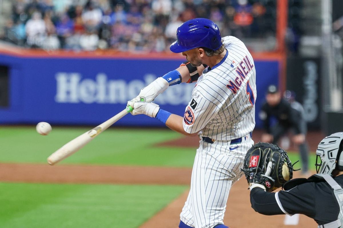 May 27, 2025; New York City, New York, USA; New York Mets second baseman Jeff McNeil (1) hits an RBI sacrifice fly during the third inning against the Chicago White Sox at Citi Field. Mandatory Credit: Vincent Carchietta-Imagn Images