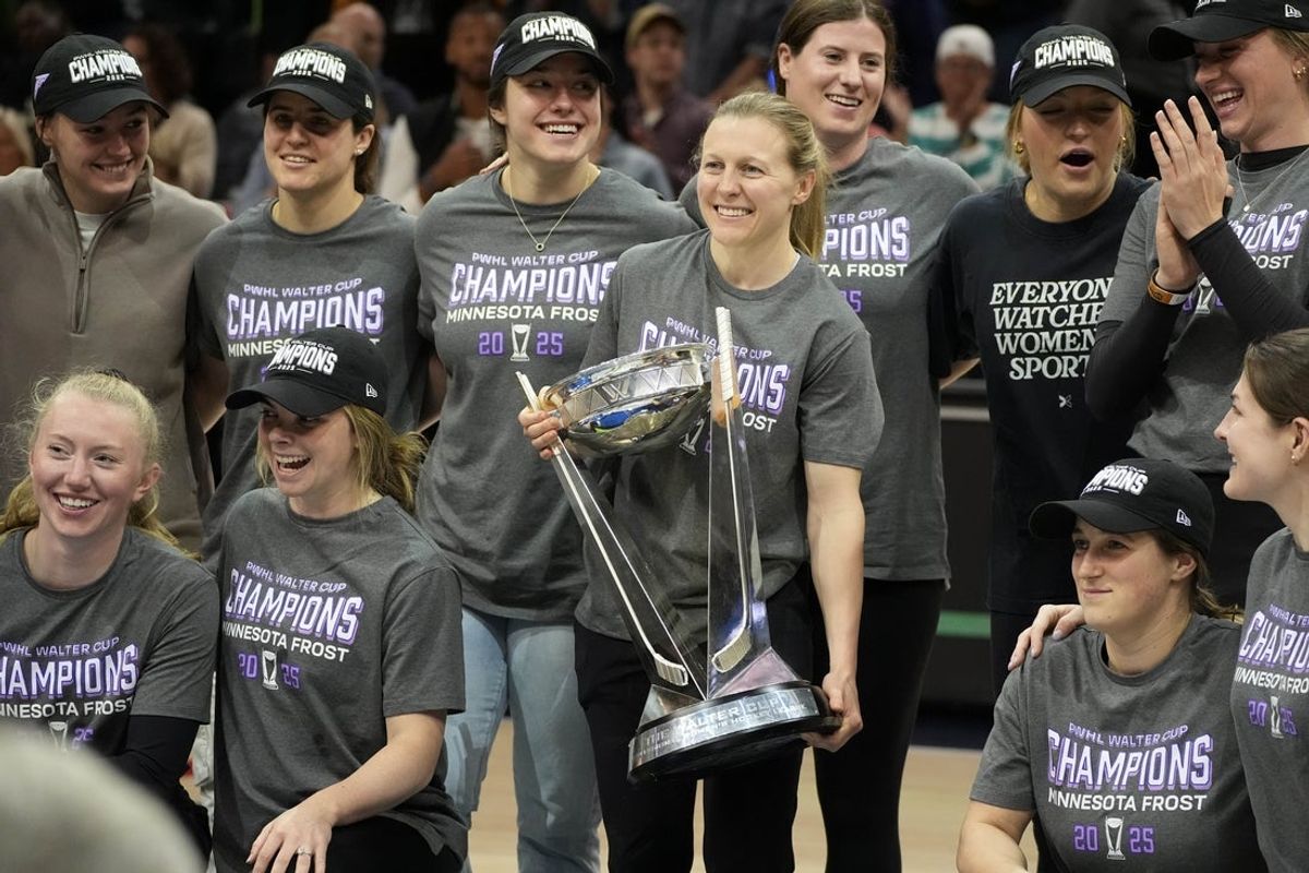 May 27, 2025; Minneapolis, Minnesota, USA; Minnesota Frost captain Kendall Coyne Schofield joined by her teammates carries the Walter Cup which they won the the night before during a break of the game between the Seattle Storm and the Minnesota Lynx at Target Center. Mandatory Credit: Bruce Kluckhohn-Imagn Images
