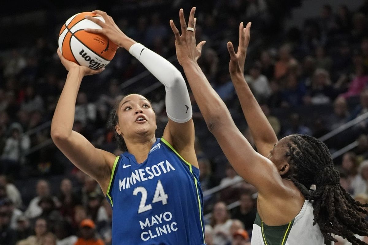 May 27, 2025; Minneapolis, Minnesota, USA; Minnesota Lynx forward Napheesa Collier (24) shoots over Seattle Storm forward Nneka Ogwumike (3) in the fourth quarter at Target Center. Mandatory Credit: Bruce Kluckhohn-Imagn Images