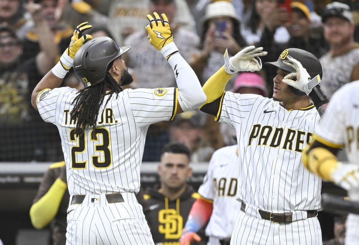 May 27, 2025; San Diego, California, USA; San Diego Padres outfielder Fernando Tatis Jr. (23) is congratulated by  Manny Machado (13) after hitting a solo home run during the first inning against the Miami Marlins at Petco Park. Mandatory Credit: Denis Poroy-Imagn Images