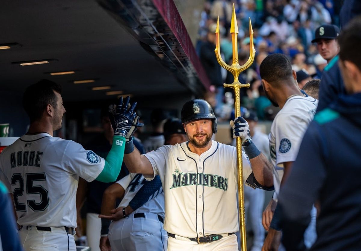 May 27, 2025; Seattle, Washington, USA;  Seattle Mariners catcher Cal Raleigh (29) celebrates in the dugout after hitting a solo home run during the fifth inning against the Washington Nationals at T-Mobile Park. Mandatory Credit: Stephen Brashear-Imagn Images