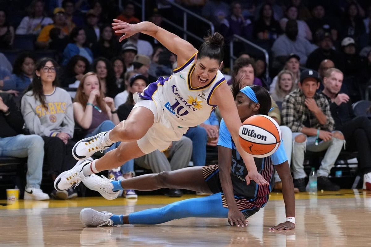 May 27, 2025; Los Angeles, California, USA; LA Sparks guard Kelsey Plum (10) is fouled by Atlanta Dream guard Maya Caldwell (33) in the first half at Crypto.com Arena. Mandatory Credit: Kirby Lee-Imagn Images