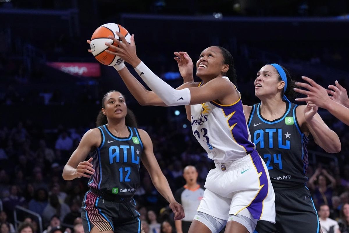 May 27, 2025; Los Angeles, California, USA; LA Sparks forward Azura Stevens (23) is defended by Atlanta Dream forward Nia Coffey (12) and forward Brionna Jones (24) in the first half at Crypto.com Arena. Mandatory Credit: Kirby Lee-Imagn Images