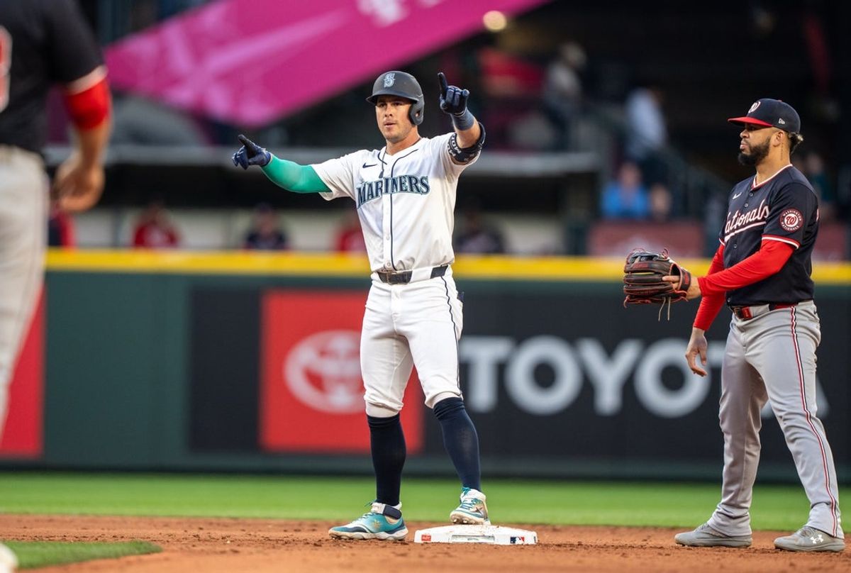 May 27, 2025; Seattle, Washington, USA;  Seattle Mariners second baseman Dylan Moore (25) celebrates at second base after hitting a double during the sixth inning against the Washington Nationals at T-Mobile Park. Mandatory Credit: Stephen Brashear-Imagn Images