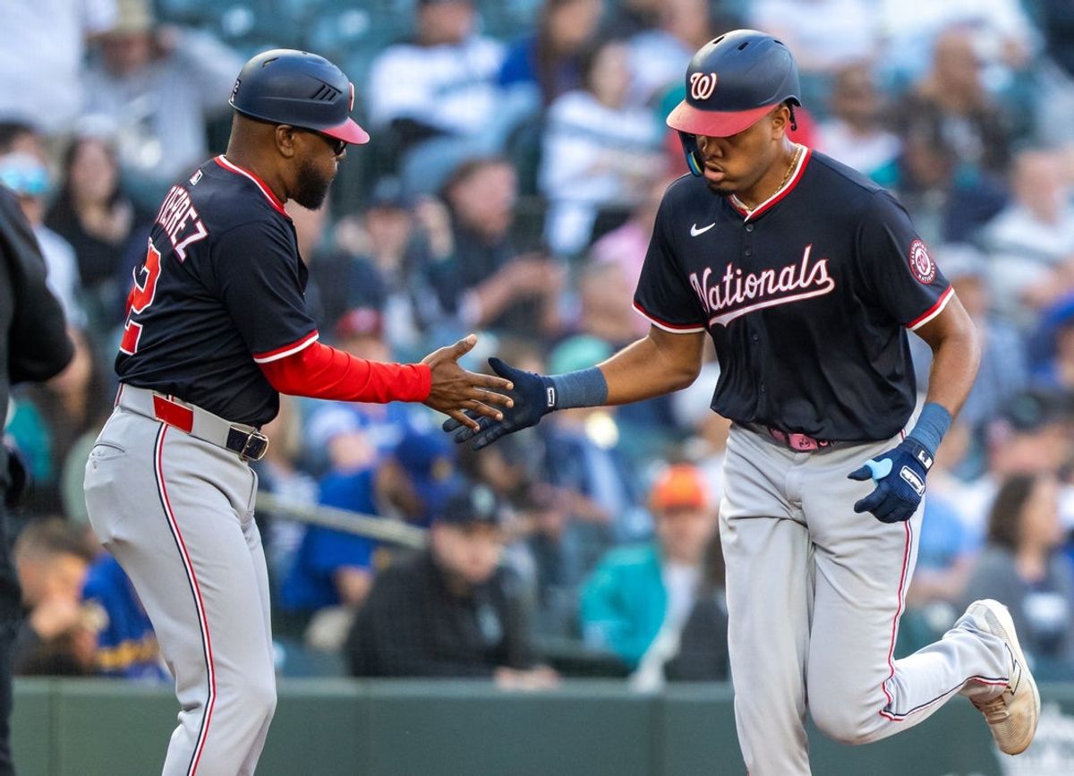 May 27, 2025; Seattle, Washington, USA;  Washington Nationals left fielder James Wood (29) is congratulated by third base coach Ricky Gutierrez after hitting a solo home run during the fourth inning against the Seattle Mariners at T-Mobile Park. Mandatory Credit: Stephen Brashear-Imagn Images