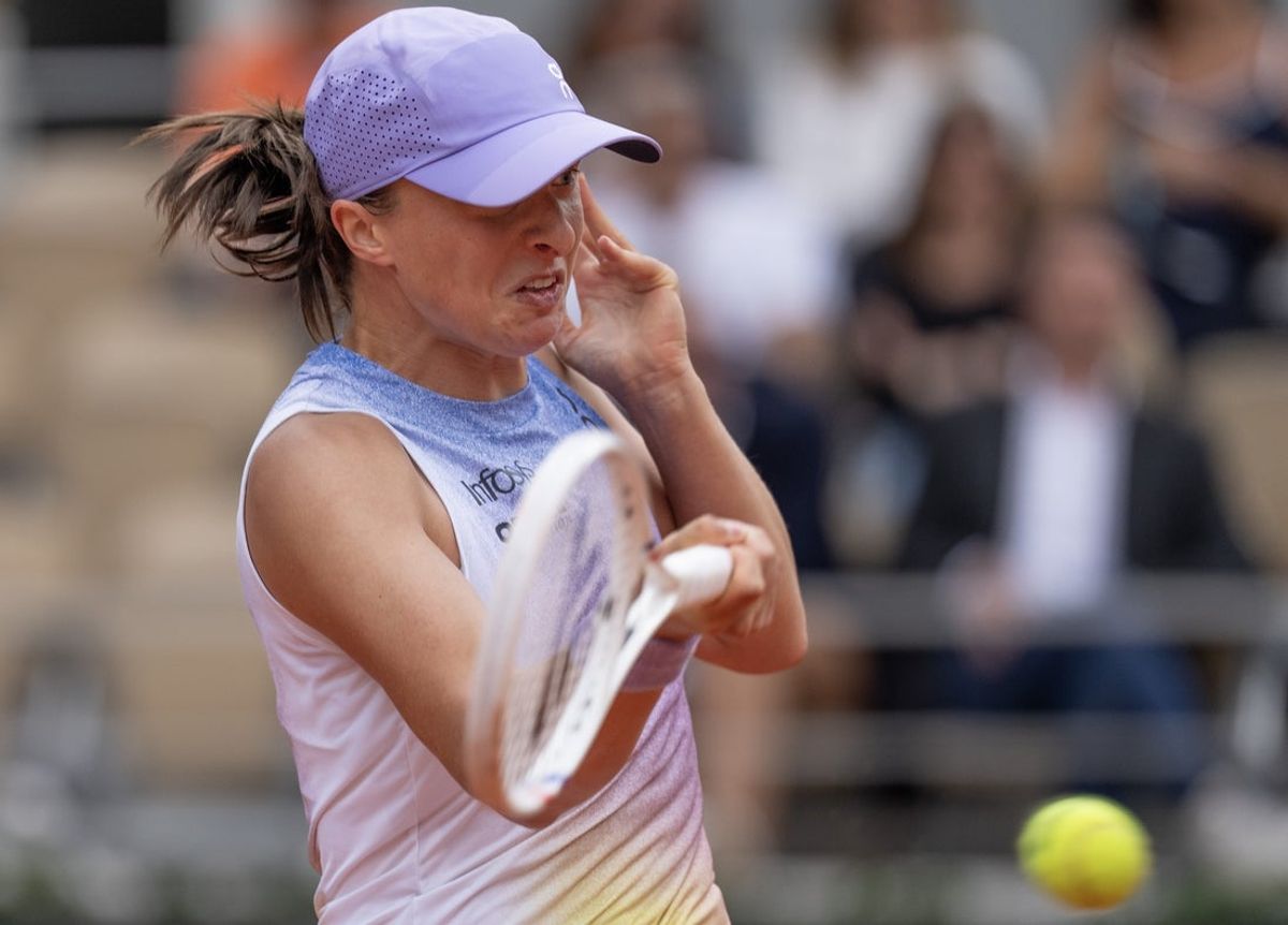 May 28, 2025; Paris, FR; Iga Swiatek of Poland returns a shot during her match against Emma Raducanu of Great Britain on day four at Roland Garros Stadium.  Mandatory Credit: Susan Mullane-Imagn Images