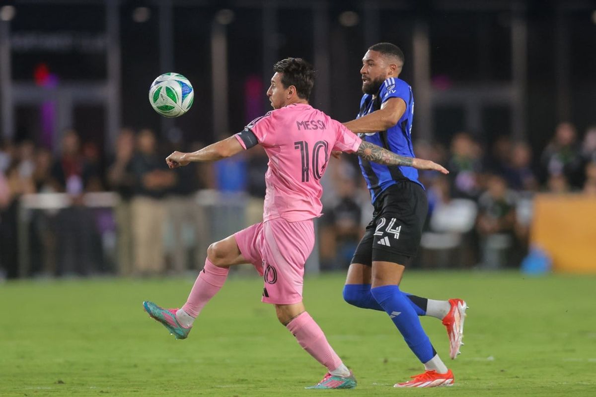May 28, 2025; Fort Lauderdale, Florida, USA; Inter Miami CF forward Lionel Messi (10) dribbles the ball against CF Montreal defender George Campbell (24) during the first half at Chase Stadium. Mandatory Credit: Sam Navarro-Imagn Images