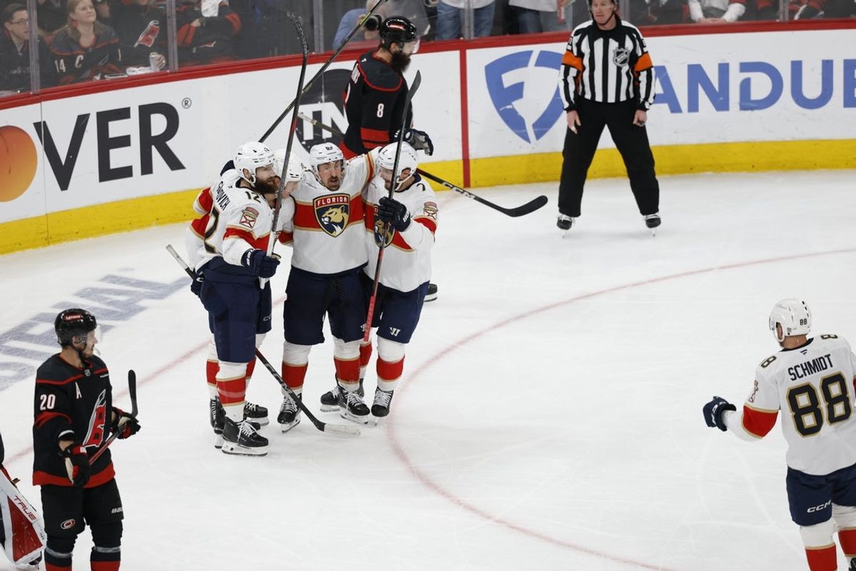 May 28, 2025; Raleigh, North Carolina, USA; Florida Panthers forward Anton Lundell (15) celebrates scoring with forward Jonah Gadjovich (12) and forward Brad Marchand (63) and defenseman Dmitry Kulikov (7) during the second period against the Carolina Hurricanes in game five of the Eastern Conference Final of the 2025 Stanley Cup Playoffs at Lenovo Center. Mandatory Credit: Geoff Burke-Imagn Images