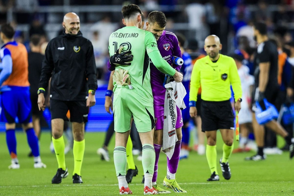 May 28, 2025; Cincinnati, Ohio, USA; FC Cincinnati goalkeeper Roman Celentano (18) hugs FC Dallas goalkeeper Maarten Paes (1) after the draw at TQL Stadium. Mandatory Credit: Katie Stratman-Imagn Images
