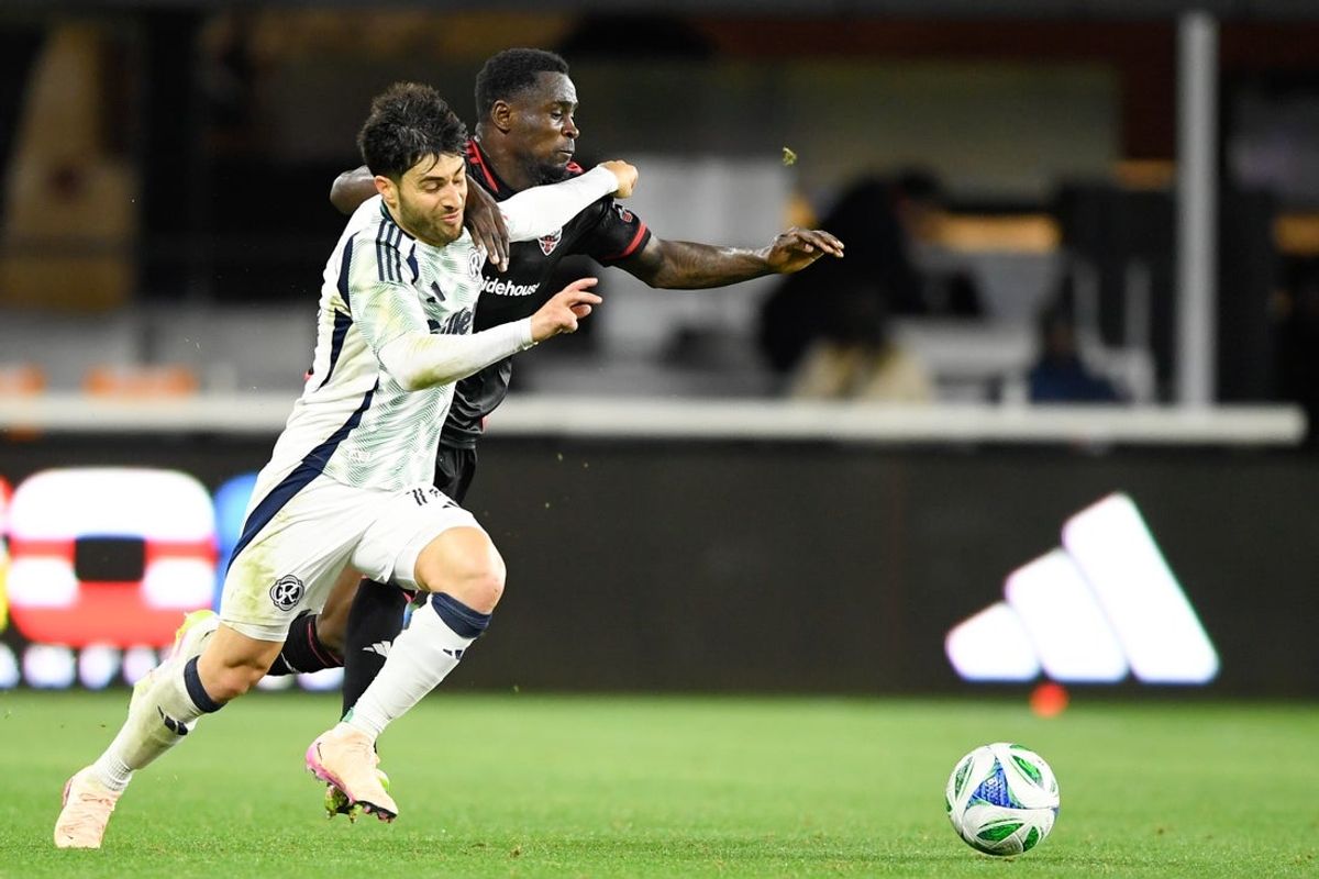 May 28, 2025; Washington, District of Columbia, USA; D.C. United midfielder Boris Enow (6) battles New England Revolution midfielder Carles Gil (10) for the ball during the second half of the game at Audi Field. Enow received a yellowcard on the play. Mandatory Credit: Hannah Foslien-Imagn Images