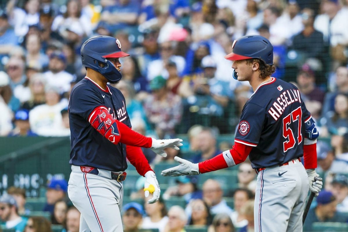 May 28, 2025; Seattle, Washington, USA; Washington Nationals second baseman Luis García Jr. (2) celebrates with center fielder Robert Hassell III (57) after hitting a solo-home run against the Seattle Mariners during the second inning at T-Mobile Park. Mandatory Credit: Joe Nicholson-Imagn Images