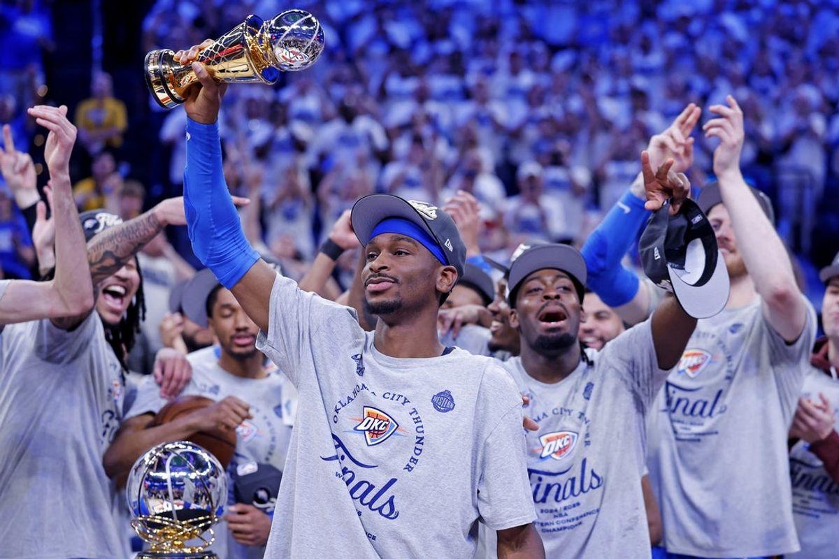 May 28, 2025; Oklahoma City, Oklahoma, USA; Oklahoma City Thunder guard Shai Gilgeous-Alexander (2) celebrates with Magic Johnson West Conference Finals MVP trophy after defeating the Minnesota Timberwolves in game five to win the western conference finals for the 2025 NBA Playoffs at Paycom Center. Mandatory Credit: Alonzo Adams-Imagn Images