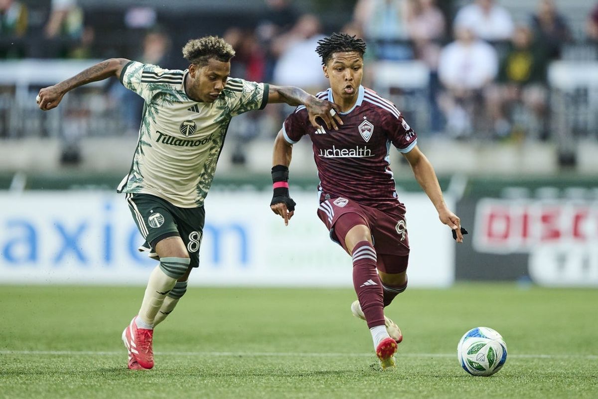 May 28, 2025; Portland, Oregon, USA; Colorado Rapids defender Jackson Travis (99) chases after the ball during the first half against Portland Timbers midfielder Joao Ortiz (80) at Providence Park. Mandatory Credit: Troy Wayrynen-Imagn Images