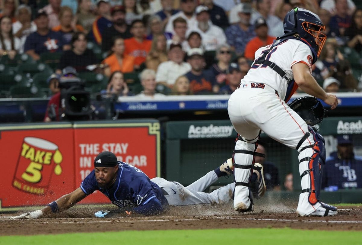 May 29, 2025; Houston, Texas, USA; Tampa Bay Rays left fielder Chandler Simpson (14) steals third base then scores a run on Houston Astros catcher Yainer Diaz (21) (not pictured) errant throw in the fourth inning at Daikin Park. Mandatory Credit: Thomas Shea-Imagn Images