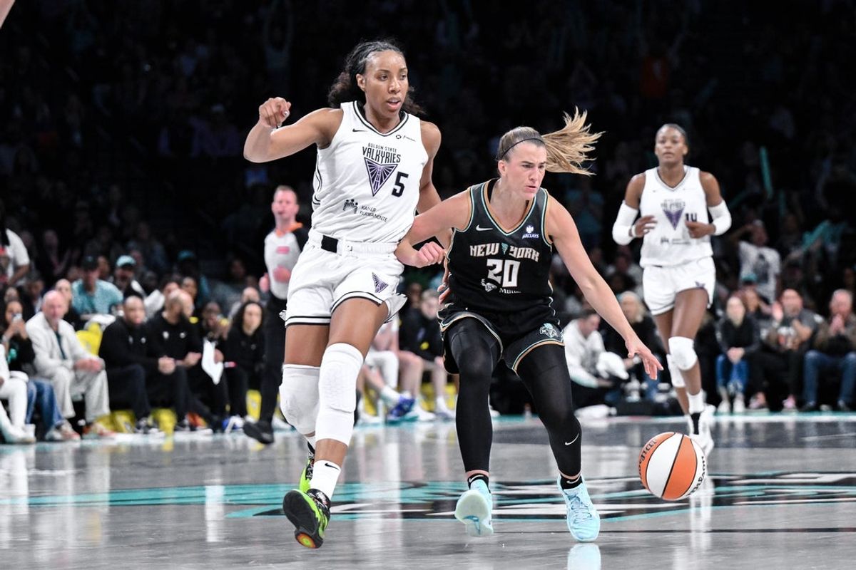 May 29, 2025; Brooklyn, New York, USA; New York Liberty guard Sabrina Ionescu (20) brings the ball up court while being defended by Golden State Valkyries forward Kayla Thornton (5) during the second half at Barclays Center. Mandatory Credit: John Jones-Imagn Images