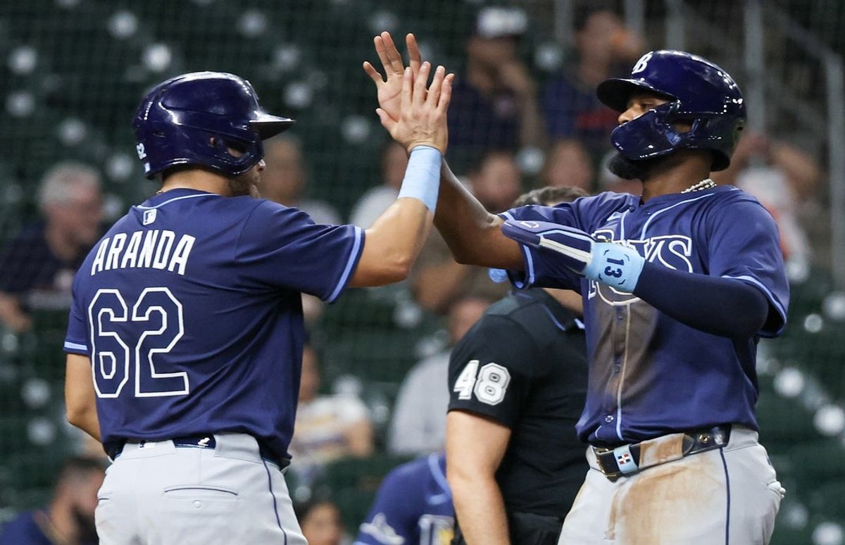 May 29, 2025; Houston, Texas, USA;  Tampa Bay Rays first baseman Jonathan Aranda (62) celebrates third baseman Junior Caminero (13) run against the Houston Astros in the eighth inning at Daikin Park. Mandatory Credit: Thomas Shea-Imagn Images