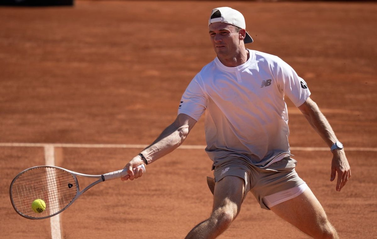 May 30, 2025; Paris, FR; Tommy Paul of the United States returns a shot during his match against Karen Khachanov on day six at Roland Garros Stadium.  Mandatory Credit: Susan Mullane-Imagn Images