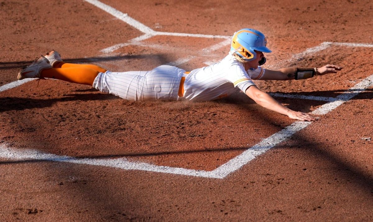 Tennessee's Laura Mealer (2) slides into home in the first inning of the Women's College World Series softball game between the Florida Gators and the Tennessee Volunteers at Devon Park in Oklahoma City, Friday, May, 30, 2025.