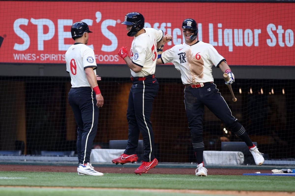 May 30, 2025; Arlington, Texas, USA; Texas Rangers outfielder Wyatt Langford (36) is congratulated after hitting a two-run home run by outfielder Sam Haggerty (0) and third base Josh Jung (6) during the second inning against the St. Louis Cardinals at Globe Life Field. Mandatory Credit: Tim Heitman-Imagn Images